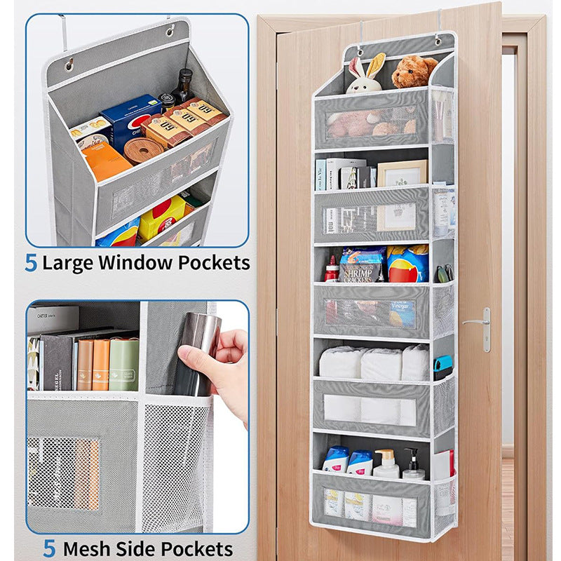 Over-the-door organizer with mesh side and large window pockets on a wooden door.