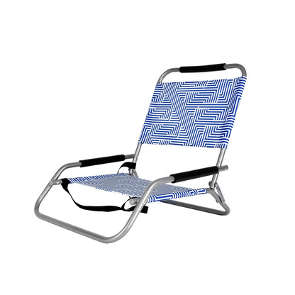 Foldable beach chair with blue patterned seat and backrest on a white background