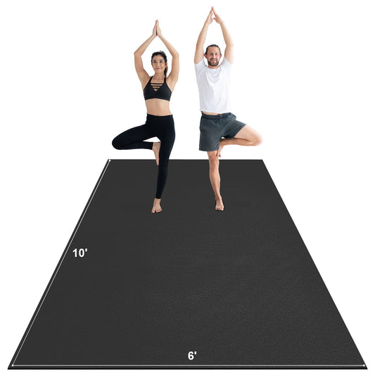 Two people performing yoga poses on a large black yoga mat with measurements.