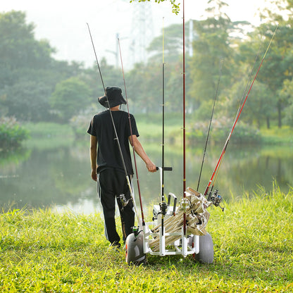 Person with multiple fishing rods and a cart by a lake