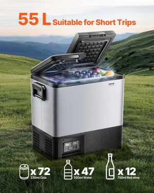 Portable refrigerator with open lid showing contents on grassy field with mountains in the background