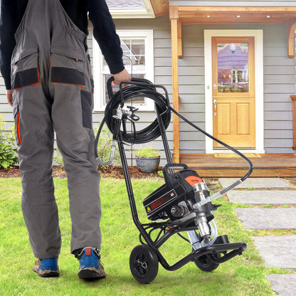 Person pushing a pressure washer on a lawn in front of a house