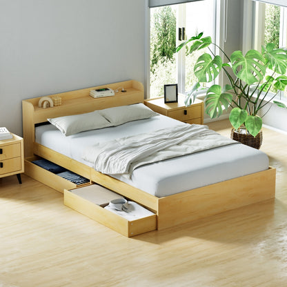 Wooden bed with storage drawers in a bright bedroom with plants