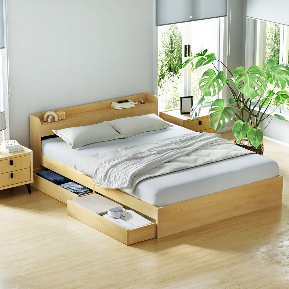 Wooden bed with storage drawers in a bright bedroom with plants