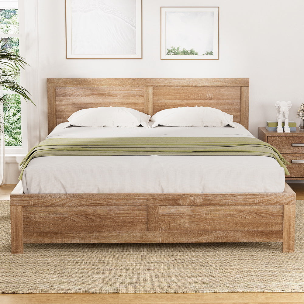 Wooden bed with white bedding and green blanket in a bedroom setting.