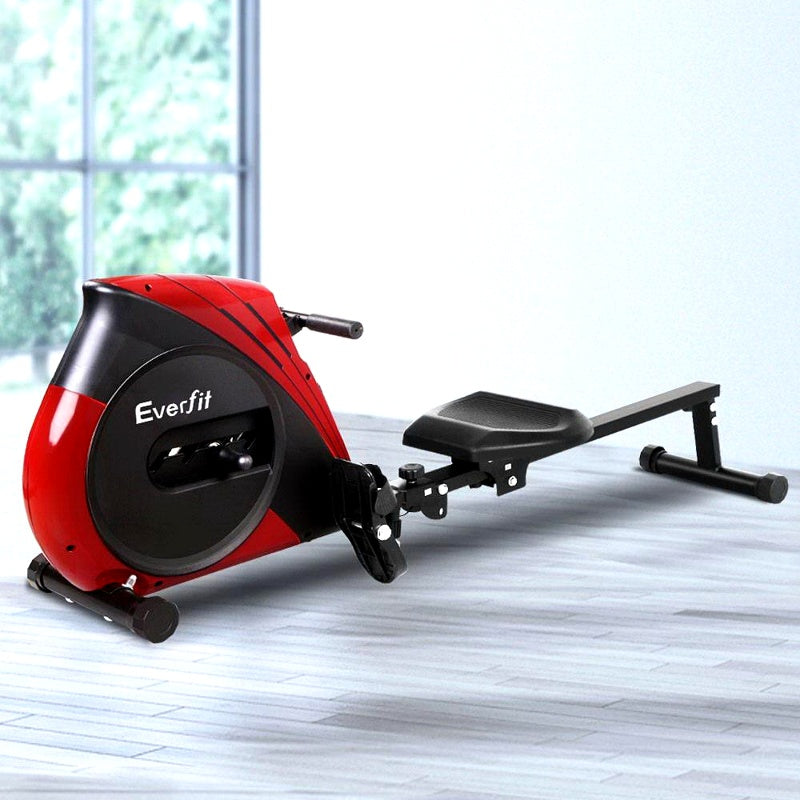Red and black Eversfit rowing machine on a light wooden floor with a blurred window background.