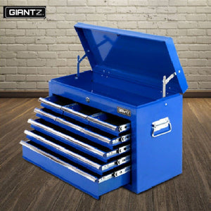 A blue Giantz tool box with multiple drawers, placed on a wooden floor against a brick wall backdrop, indicating a sturdy construction with a matte finish.