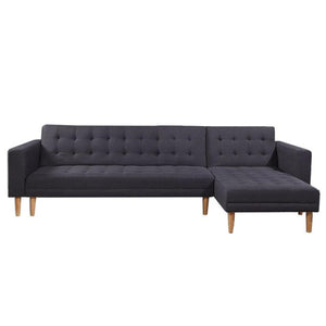 A dark grey linen upholstered corner sofa with tufted surface and wooden legs, featuring a chaise lounge.