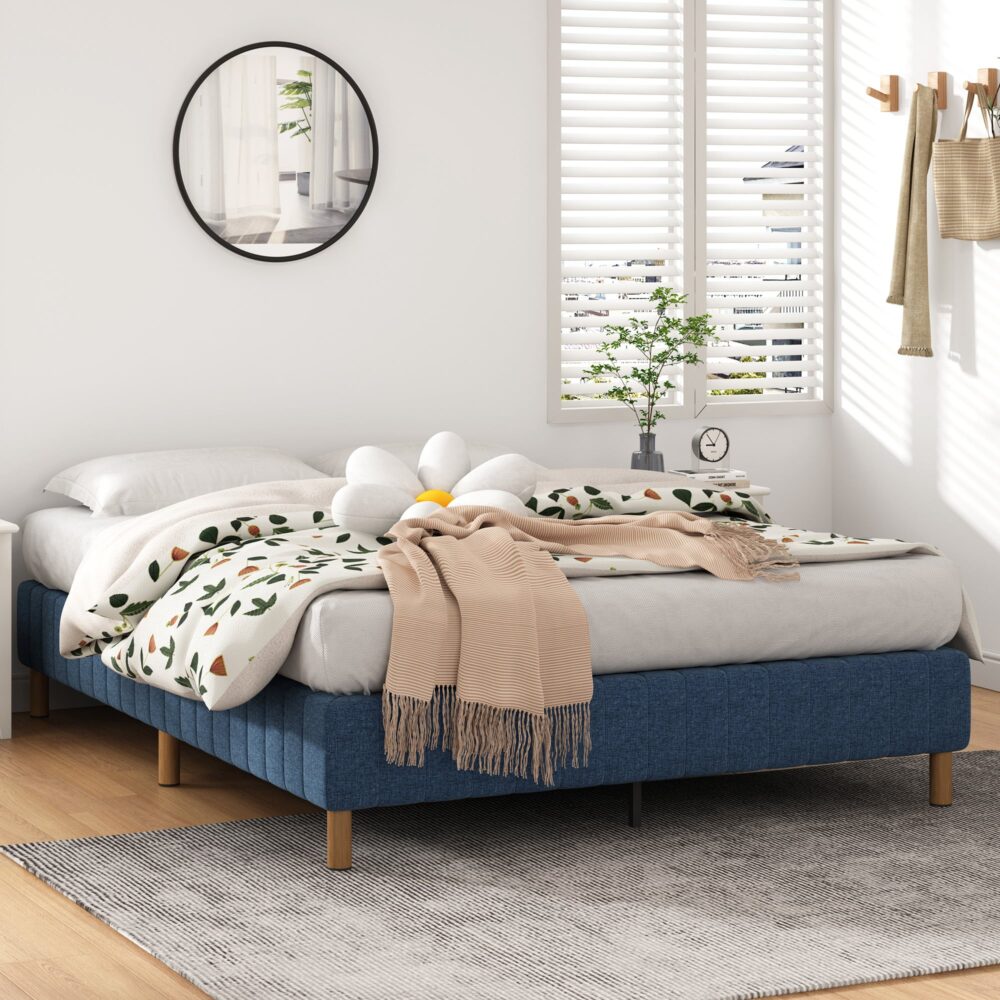A blue metal bed frame with a queen size, featuring a linen cover, six stable bed legs, and a rust-resistant powder-coated finish in a bedroom setting.