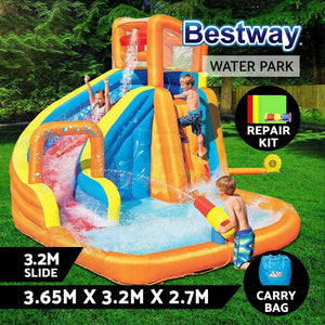 An inflatable water slide and pool toy featuring a curved slide, splash pool, climbing wall, and mesh-protected bouncing playpen. It is set up outdoors with children playing on it.